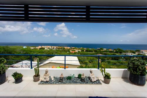 a balcony with a view of the ocean at Westpunt Beach Apartments in Willemstad