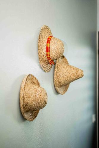 a pair of santa hats hanging on a wall at VT cottage in Rivière-Pilote
