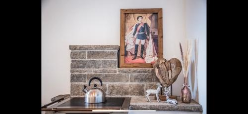 a fireplace with a picture of a man on the wall at Hirsch Chalet #Sauna in Lechbruck