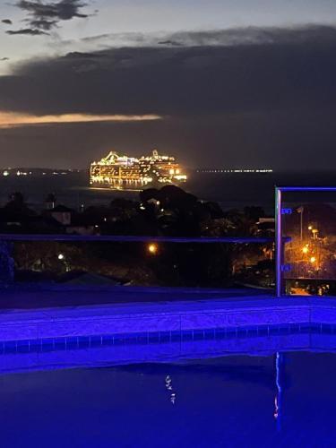 a view of a building at night from a swimming pool at Casa Espetacular - João Fernandes - NÃO ACEITAMOS PETS in Búzios