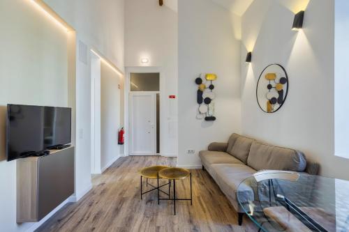 Una sala de estar con un sofá y una mesa de cristal. en Golden Setubal, en Setúbal