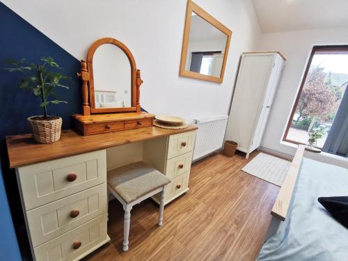 a bathroom with a dresser with a mirror on it at The Bakery in Pilling