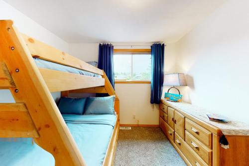 a bedroom with two bunk beds and a window at Camano Waterfront Delight in Saratoga Shores