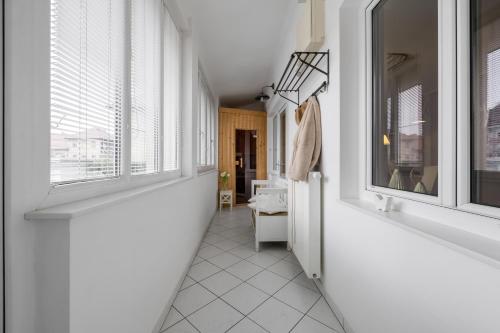 a hallway with white walls and windows in a room at City Central in Ljubljana