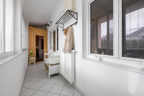 a hallway with windows and a coat on a rack at City Central in Ljubljana