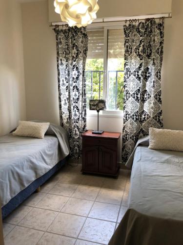 a room with two beds and a window at Departamento Centrico travel & business in San Salvador de Jujuy