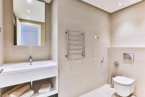a bathroom with a sink toilet and a mirror at Montesun RAF Apartments in Budva