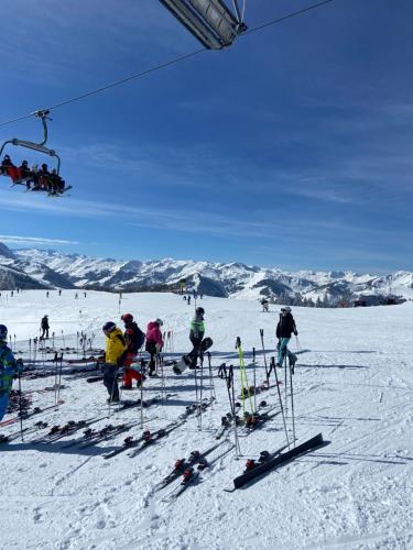 a group of people on a ski lift in the snow at Landgasthof Dorfstadl in Kössen