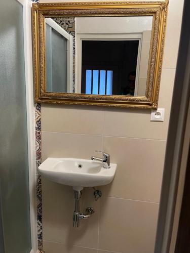 a bathroom with a sink and a mirror at Apartmány Modrý Dom in Podhájska
