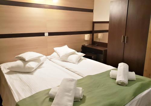a hotel room with a bed with towels on it at Traveland Boutique Resort Poiana Brasov in Poiana Brasov