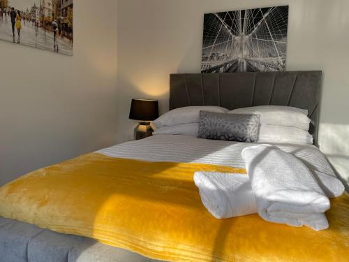 a bedroom with a large bed with towels on it at Traditional with Views in Wem