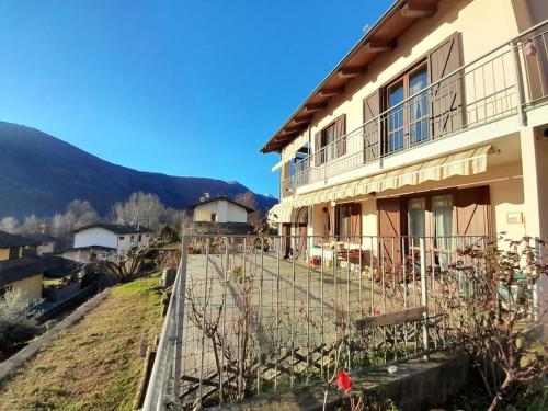 a building with a fence in front of it at Casa Vacanze Le tre Sorelle in Torre Pellice