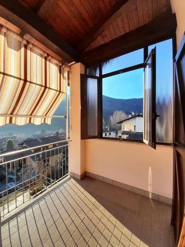 a room with a large window with a view at Casa Vacanze Le tre Sorelle in Torre Pellice