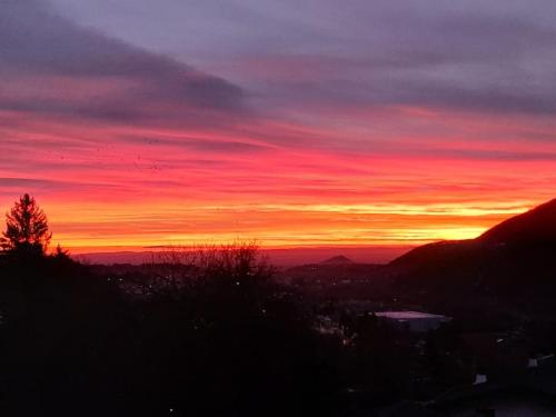 a sunset with the sun setting in the sky at Casa Vacanze Le tre Sorelle in Torre Pellice
