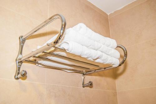 a towel rack in a bathroom with white towels at Ana María in Granada