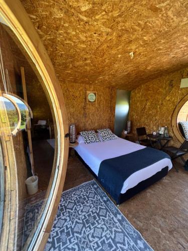 a bedroom with a bed in a stone room at Complejo turístico Magic Bungalow in Villa de Leyva