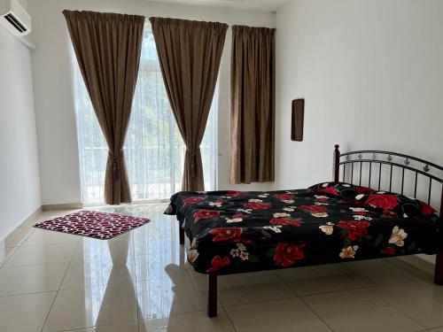 a bedroom with a bed and a window with curtains at De Pontian Homestay in Pontian Besar