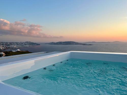 a swimming pool with a view of the water at La Maison Blanche in Agios Stefanos