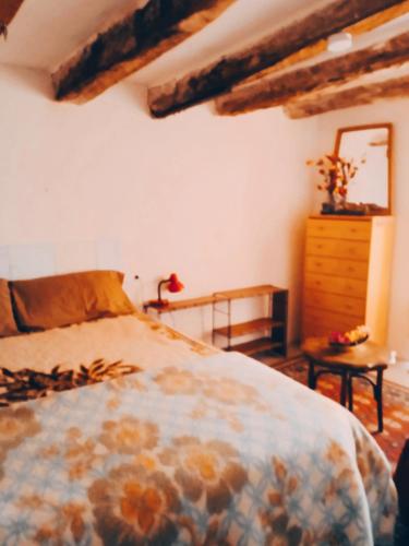 a bedroom with a bed and a dresser and a mirror at Sidharta Room in Villalba dels Arcs