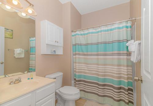 a bathroom with a toilet and a sink and a shower at Barefoot Beach Haven at Barefoot Resort & Golf - 3rd Floor- Close to Everything in North Myrtle Beach
