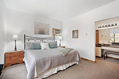 a bedroom with a bed and a desk and a piano at Beautiful Seven Springs- 2 Bed, 2 Bath Condo in Champion