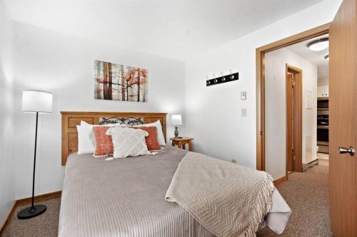 a bedroom with a large bed with orange and white pillows at Beautiful Seven Springs- 2 Bed, 2 Bath Condo in Champion
