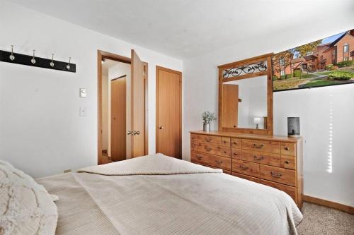 a bedroom with a bed and a dresser and a mirror at Beautiful Seven Springs- 2 Bed, 2 Bath Condo in Champion