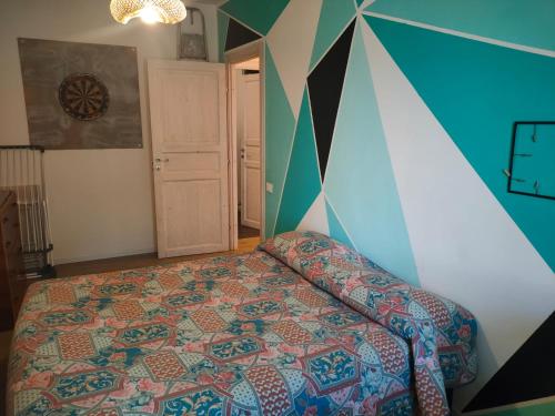 a bedroom with a bed and a geometric wall at La casa di Piera e Gina in Perugia