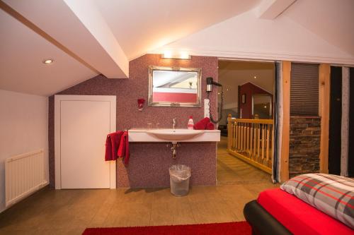 a bathroom with a sink and a bed in a room at Landhaus Celina - Panoramastall Roßberg in Neukirchen am Großvenediger