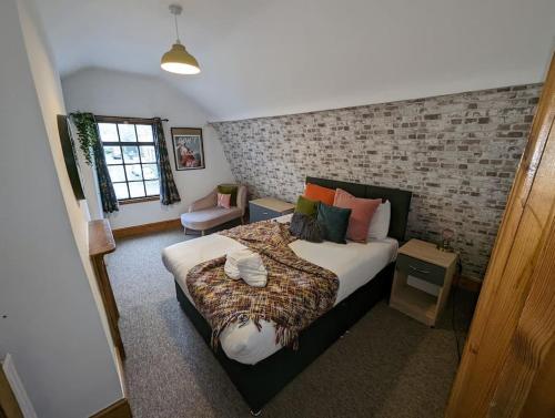 a bedroom with a bed and a brick wall at River Street Rest in Bath