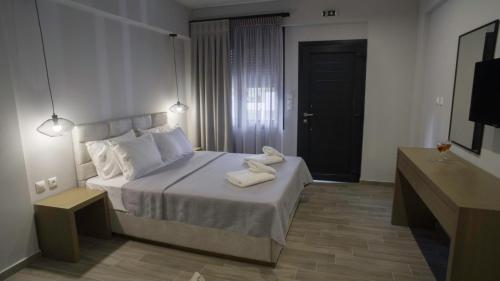1 dormitorio con 1 cama con 2 toallas en Perla Inn, en Stavros