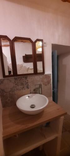 a bathroom with a white sink and two mirrors at Casa Fabian in Polopos