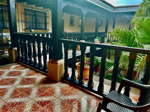 a balcony with a black railing and some plants at Real Marquez Hotel in Antigua Guatemala