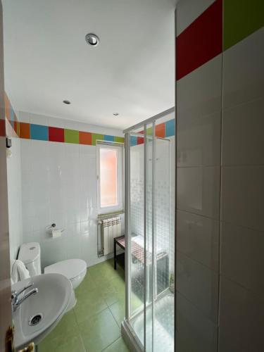 y baño con aseo y lavamanos. en Hosteria Tajahierro, en Reinosa