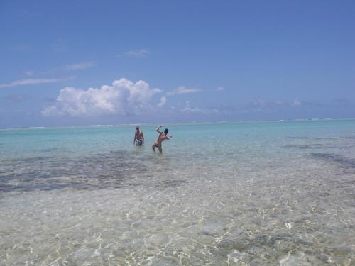 three people playing in the water on the beach at Libertalia Hotel in Sainte Marie