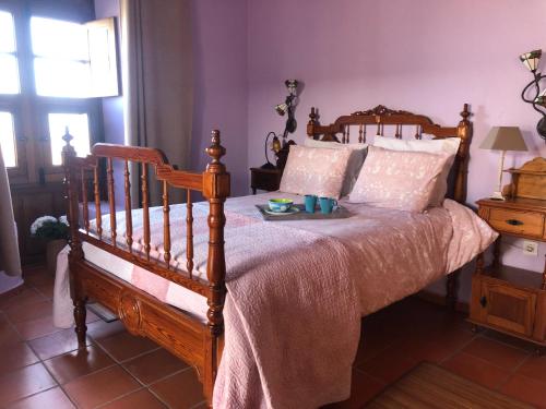 a bedroom with a bed with a tray of food on it at Casona La Orilla 1908 Tías in Tías