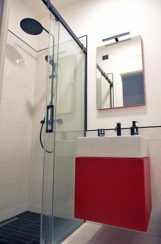 a bathroom with a red sink and a shower at ORTI19 in Maiori