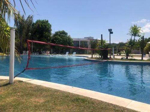 a pool with a volley ball net in it at Cobertura 3Q ILOA Barra de S Miguel Castelo B Temporada in Barra de São Miguel