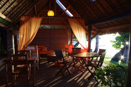 a patio with tables and chairs and a couch at Libertalia Hotel in Sainte Marie