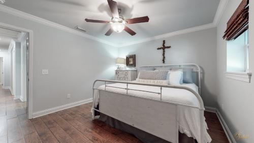 a bedroom with a bed with a ceiling fan at Private Pool - Steps To Beach - Fenced Backyard - FLPCB74 in Panama City Beach