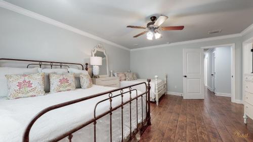 a bedroom with a bed and a ceiling fan at Private Pool - Steps To Beach - Fenced Backyard - FLPCB74 in Panama City Beach