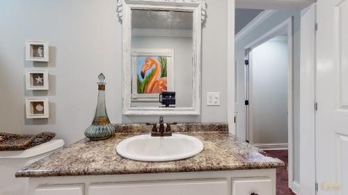 a bathroom with a sink and a mirror at Private Pool - Steps To Beach - Fenced Backyard - FLPCB74 in Panama City Beach
