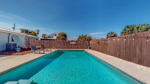 a swimming pool in front of a wooden fence at Private Pool - Steps To Beach - Fenced Backyard - FLPCB74 in Panama City Beach