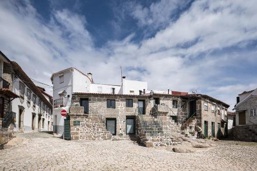 an old stone building on a cobblestone street at Casas Rossio by Casas com Estória Boutique Houses in Santa Comba Dão