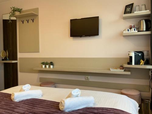 a hotel room with a bed with towels on it at Guest Rooms Tsarevets in Veliko Tŭrnovo