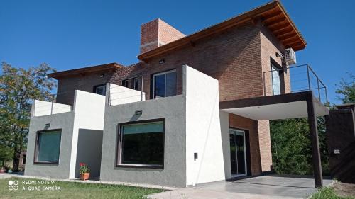 a large house with a brick at DelViento Cabañas in Las Rabonas