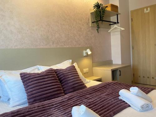 a bedroom with a large bed with two towels on it at Guest Rooms Tsarevets in Veliko Tŭrnovo