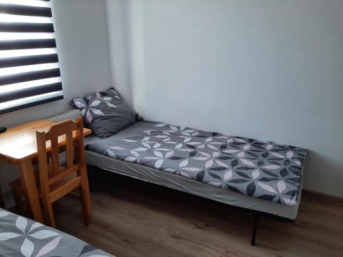 un piccolo letto futon in una camera con tavolo di Villa Basia pokoje z łazienkami a Rybnik
