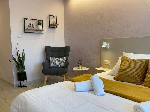 a hotel room with a bed and a chair at Guest Rooms Tsarevets in Veliko Tŭrnovo