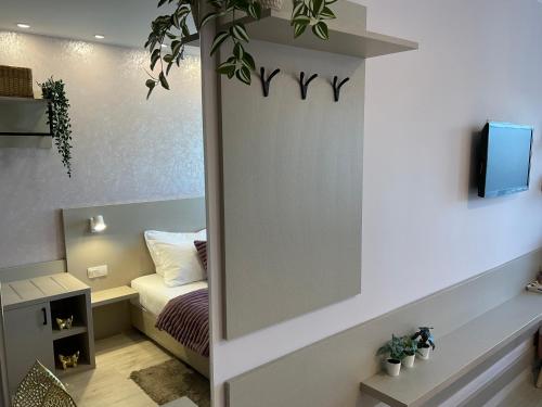 a small bedroom with a bed and a tv at Guest Rooms Tsarevets in Veliko Tŭrnovo